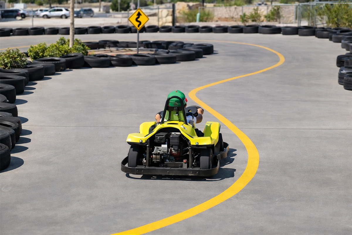 Yellow go-kart driving on a paved outdoor track